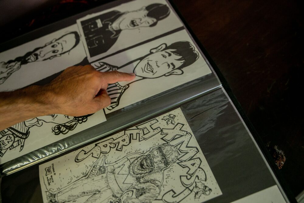 Close-up of a manga artist's desk with drawing tablet, pens, ink and printed comic pages in a Tokyo studio