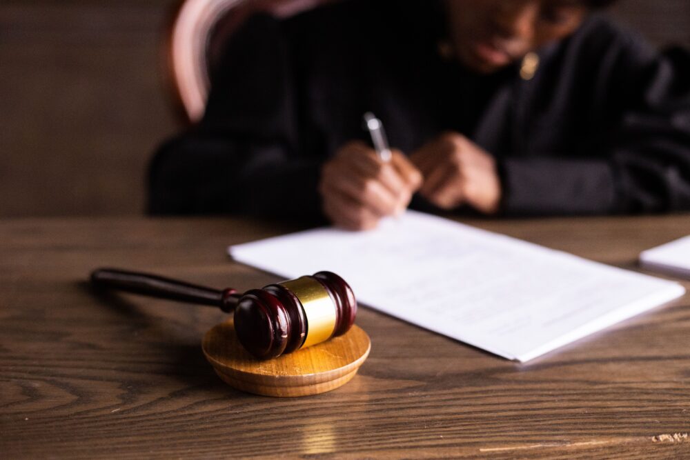 Empty courtroom in London with wooden benches and legal documents on a desk, natural light