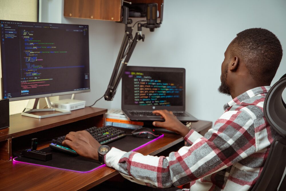 Office workers at computer screens in a data annotation and content moderation center in Nairobi, Kenya, open plan...
